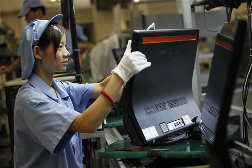In this photo taken Aug. 11, 2010, a Chinese worker labors at a production line at the factory of Lenovo Electronic Technology Co., Ltd. in Shanghai. Japan lost its place as the world's No. 2 economy to China in the second quarter as receding global growth sapped momentum and stunted a shaky recovery. (AP Photo/Eugene Hoshiko)